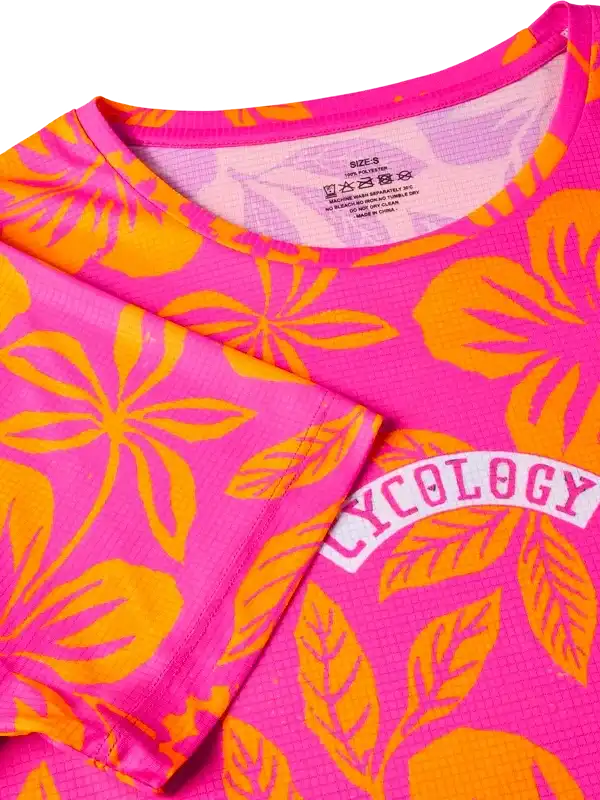 Pink and orange floral cycling jersey with 'CYCOLOGY' logo, lightweight fabric for women's bike wear
