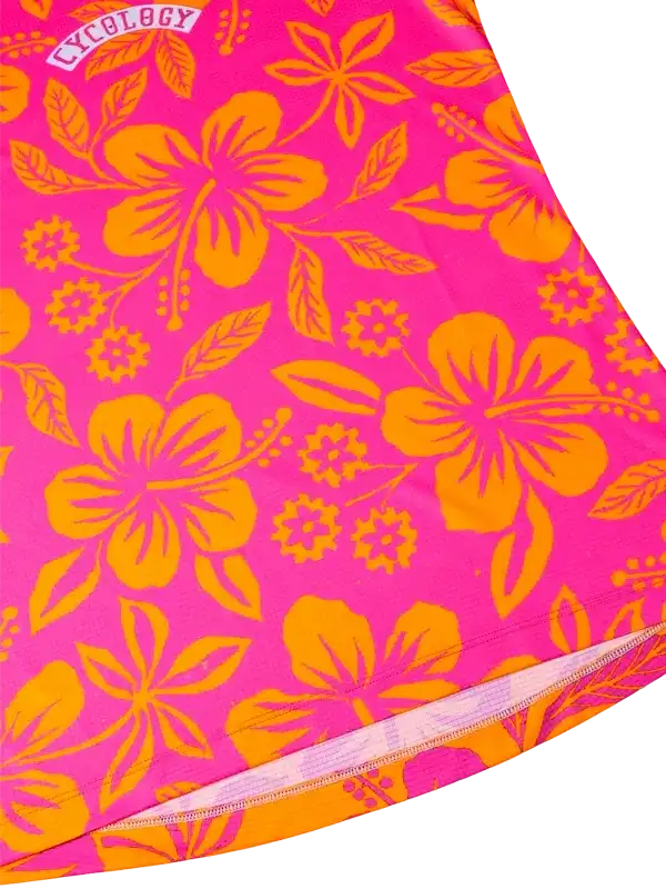 Vibrant pink cycling jersey with bold orange hibiscus floral print, ideal for women's bike wear.