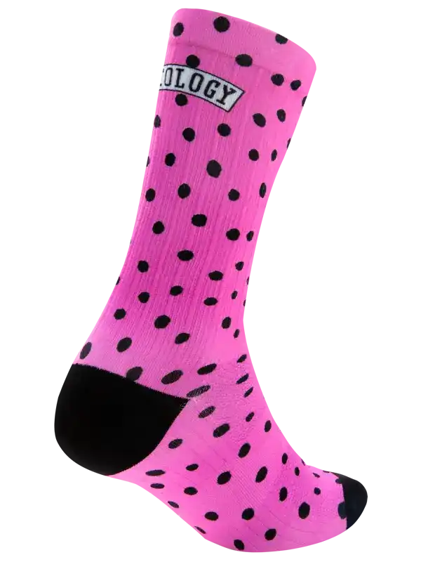 Pink cycling sock with black polka dots and logo, designed for comfort and style on rides.