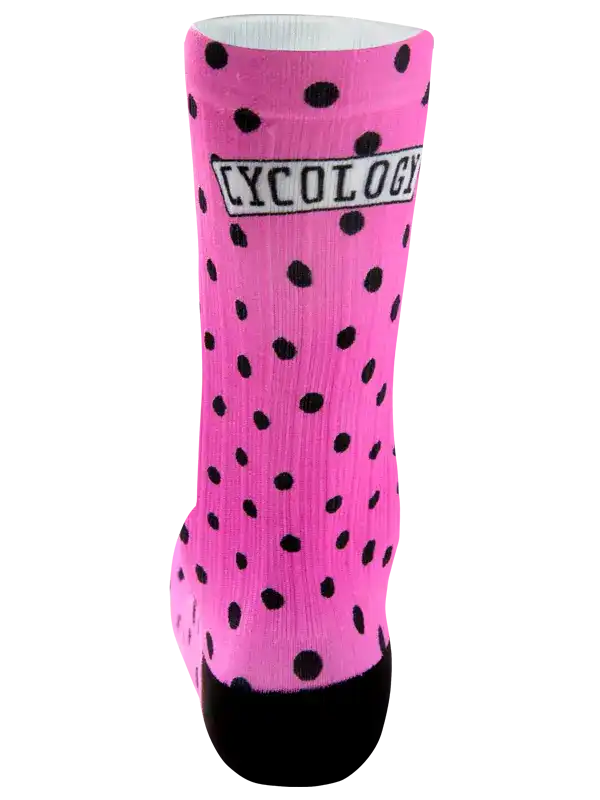 Pink cycling sock with black polka dots and CYCOLOGY logo, designed for comfort and style on rides.