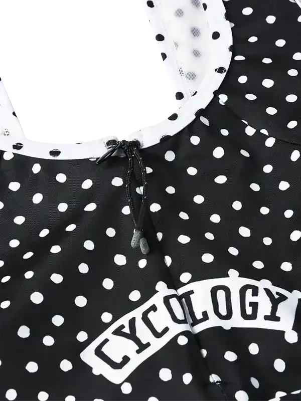 Black and white polka dot cycling jersey with 'CYCOLOGY' logo and drawstring neckline
