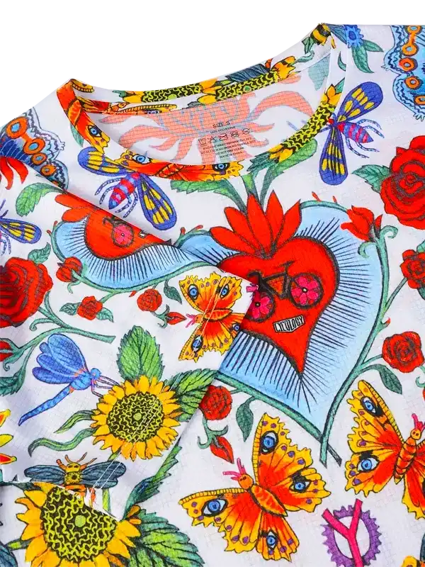 Colorful floral and butterfly print cycling jersey with heart design, vibrant summer ride apparel