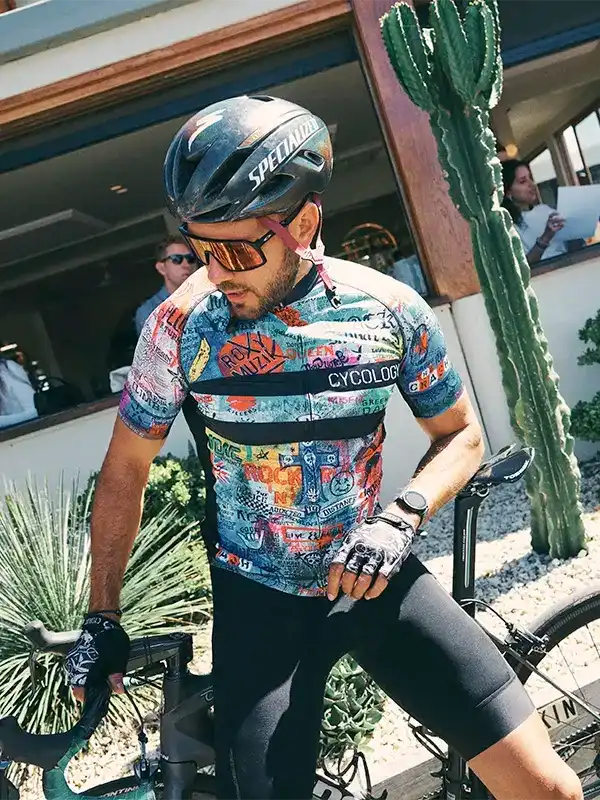 Man in colorful Cycology cycling jersey and Specialized helmet, ready to ride outdoors