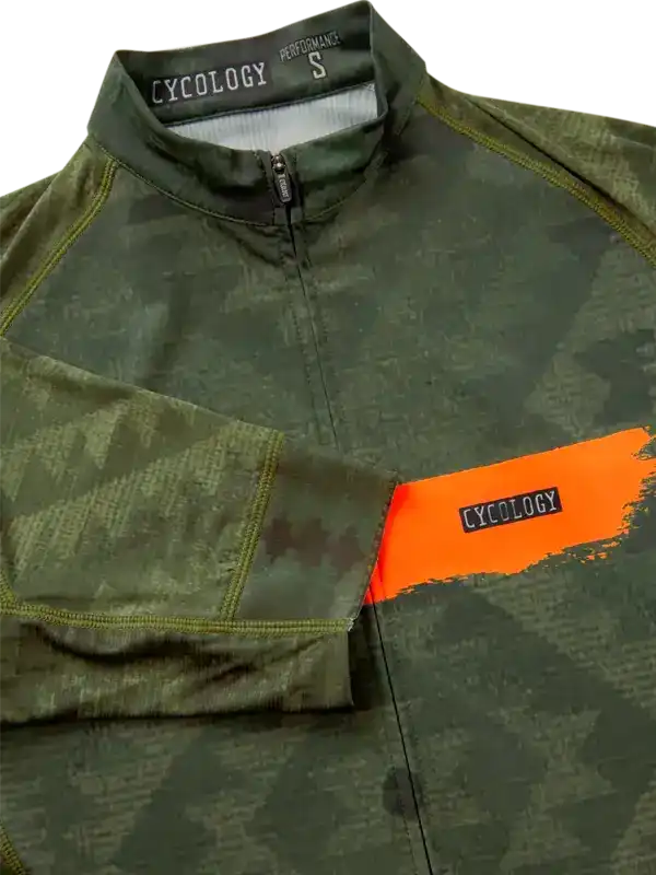 Men's cycling jersey with green camo print, orange accent, and half-zip front for performance rides