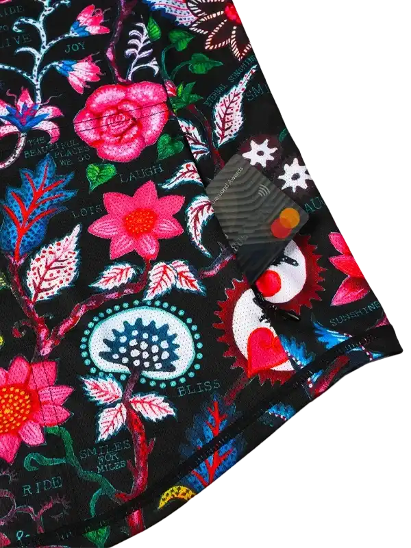 Vibrant floral cycling jersey with pink roses, blue leaves, and motivational phrases on black fabric