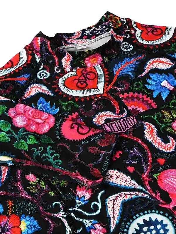 Vibrant floral cycling jersey with bold heart and bike designs, perfect for road rides