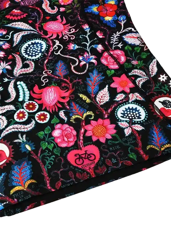 Vibrant floral and bicycle print on black cycling apparel, featuring colorful blooms and ride-themed motifs.