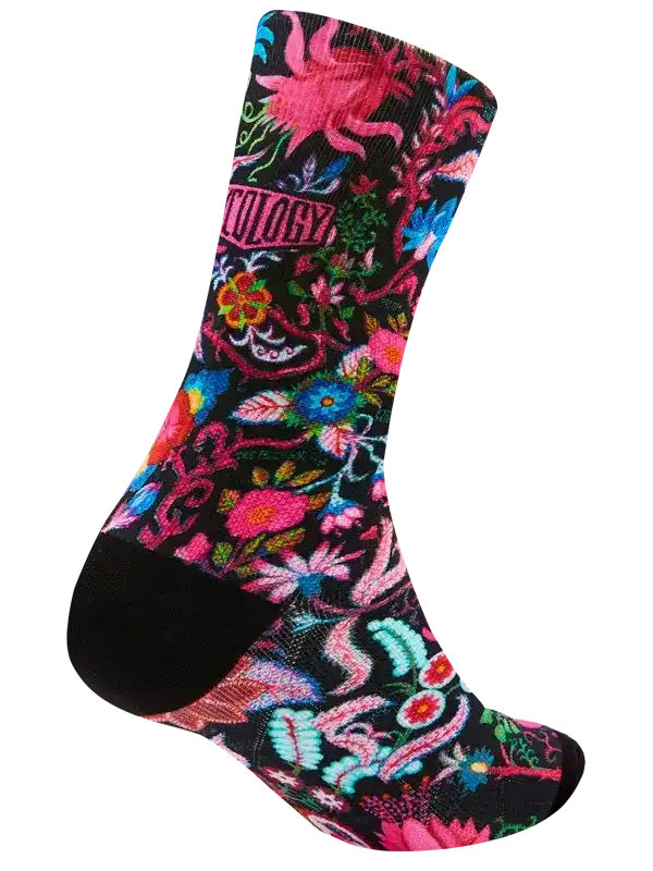 Colorful floral cycling sock with vibrant pink, blue, and green patterns on black background