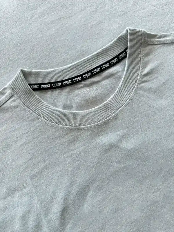 Light gray cycling t-shirt with branded neck tape, soft fabric detail for men and women