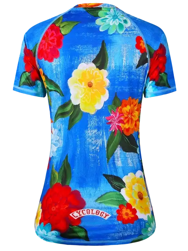 Women's cycling jersey with vibrant floral print on blue background, featuring Cycology logo