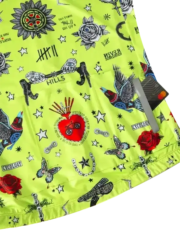 Vibrant neon green cycling jersey with tattoo-style graphics, roses, stars, and bold text designs.