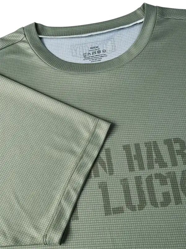 Olive green cycling jersey with grid texture and bold graphic print, designed for men's and women's bike rides.