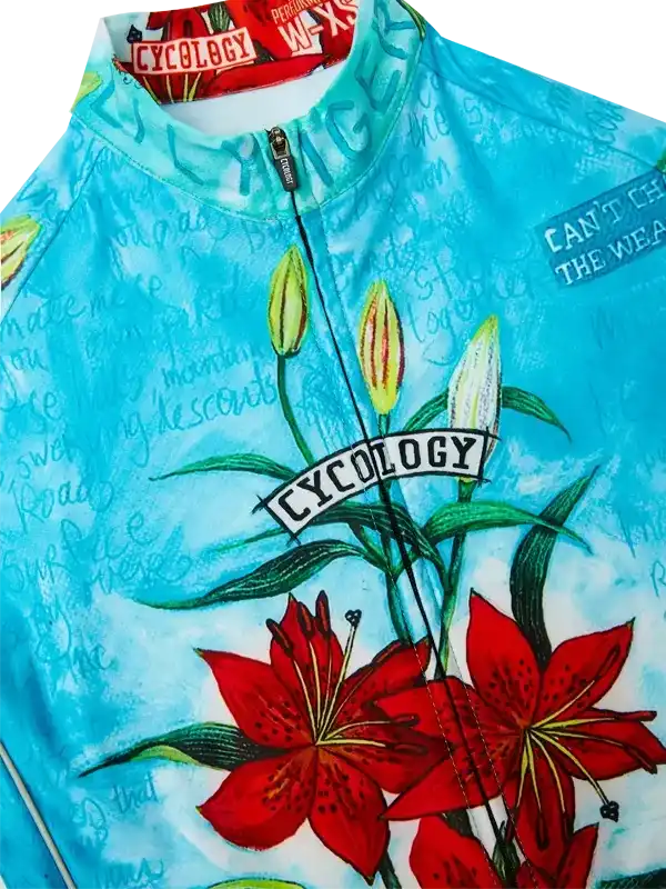 Blue cycling jersey with red lily print and 'CYCOLOGY' logo, featuring floral design and zip front