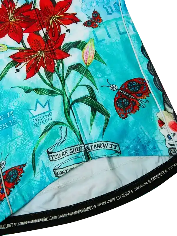 Cycling jersey with red lilies, butterflies, and 'Cycling Queen' print on teal fabric