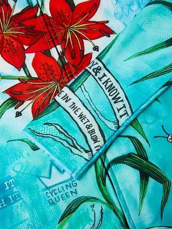 Cycling Queen floral print cycling jersey with red lilies and teal background, women's bike apparel