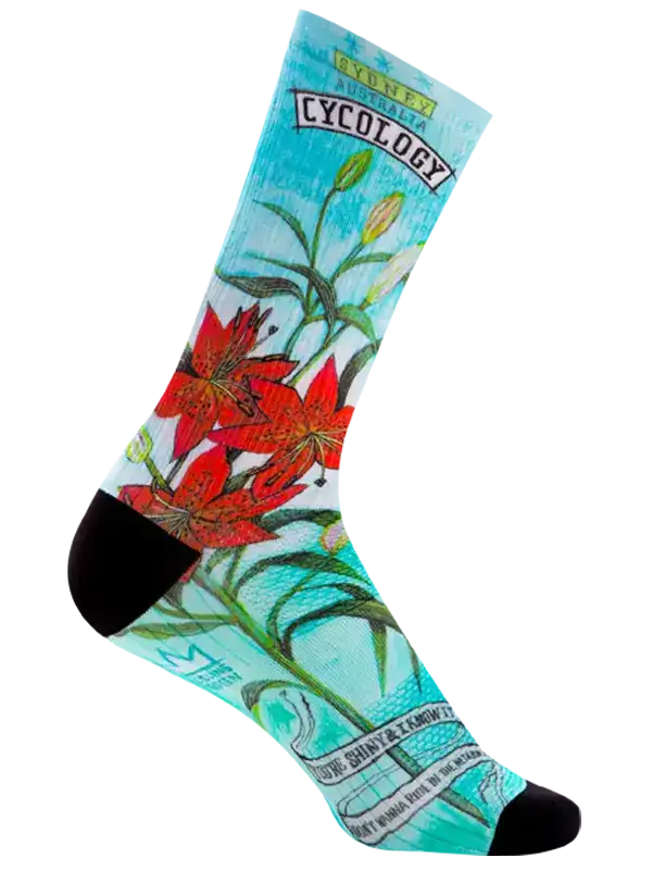 Cycling sock with red lily floral print, turquoise background, and black toe/heel for men's or women's bike rides