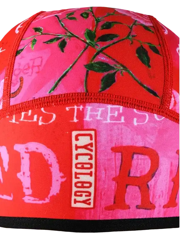 Cycology cycling cap with pink floral print and bold red lettering, designed for men and women riders