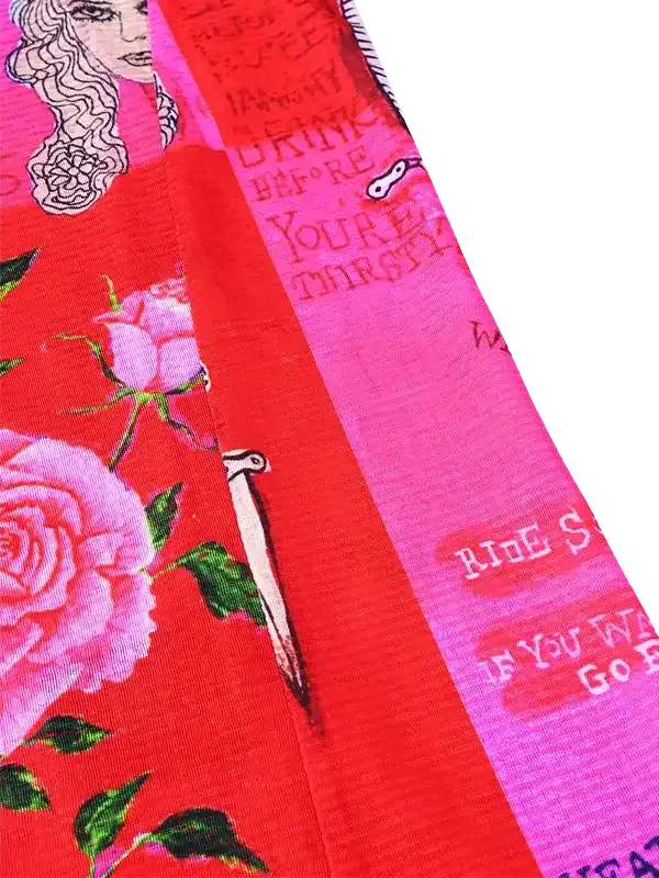 Vibrant red cycling jersey with pink roses, vintage text, and artistic graphic details for women's ride wear