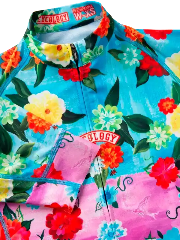Vibrant floral cycling jersey with colorful blooms and pink accents, perfect for women's bike rides.