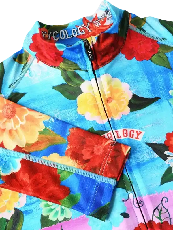 Floral print cycling jersey with vibrant red, yellow, and blue flowers on blue background, full zip front