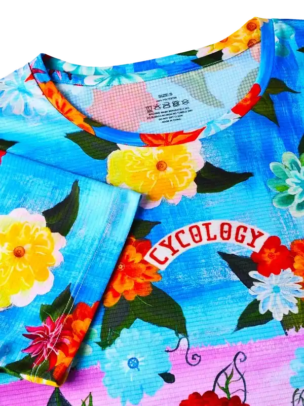 Cycology floral cycling jersey with vibrant flowers and bold colors, designed for women's bike rides.