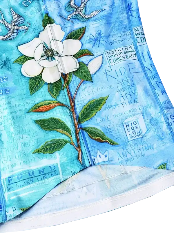 Blue cycling jersey with white flower print and motivational quotes, designed for men and women riders.