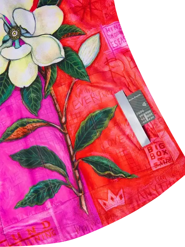 Vibrant floral cycling jersey with pink and red hues, green leaves, and artistic print details