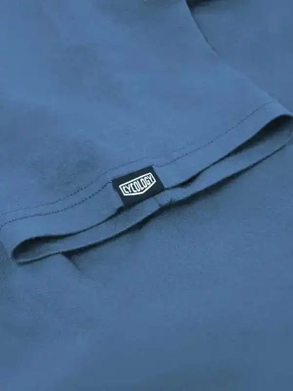 Blue cycling jersey with Cycology brand tag, high-quality fabric detail for men's and women's bike wear