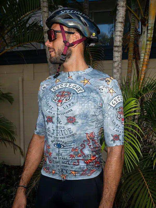 Men's cycling jersey with tiger and tattoo-style graphics, worn with helmet outdoors