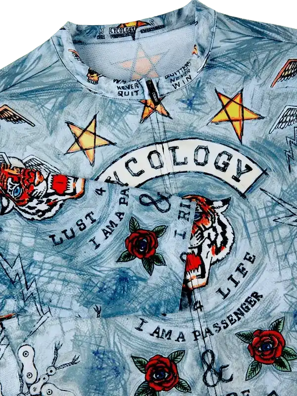 Men's cycling jersey with tiger, roses, stars, and 'Cycology' print on light blue fabric