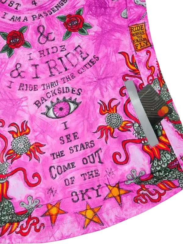 Vibrant pink cycling shorts with bold floral, star, and eye graphics, featuring edgy typography for urban riders.