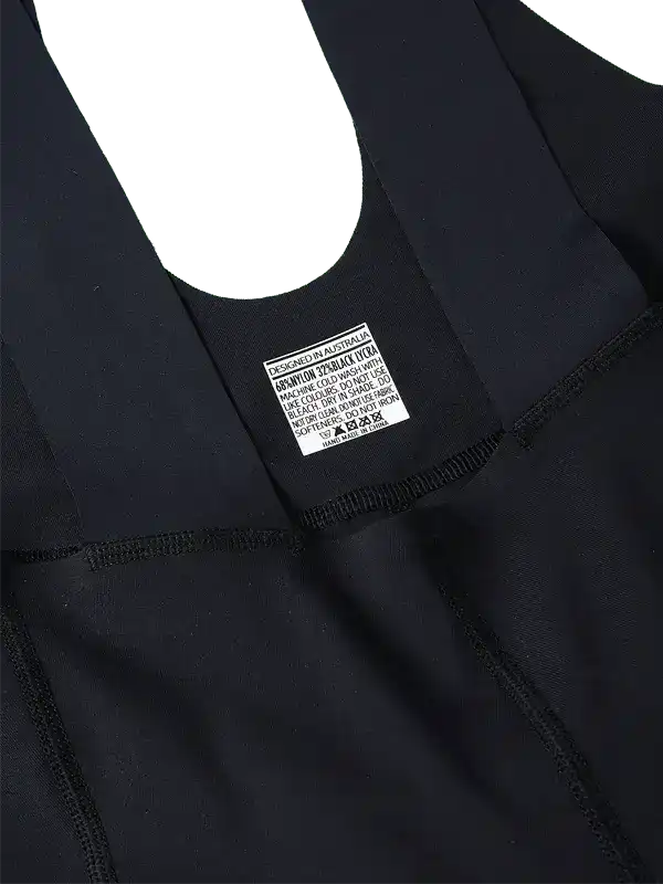 Black cycling bib shorts with care label, designed in Australia, high-quality fabric for performance