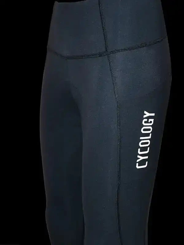 Black women's cycling tights with white Cycology logo, high-waisted design for comfort and performance.