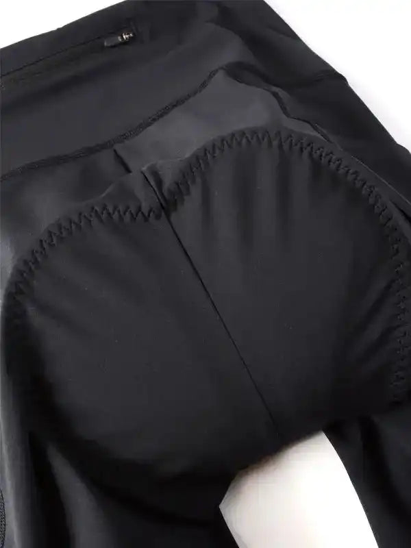 Black cycling shorts with padded chamois for comfort, designed for men and women riders.