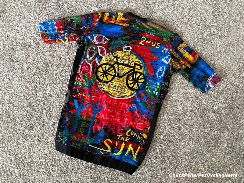 Colorful cycling jersey with bold graphic art, bike design, and motivational text for men and women riders