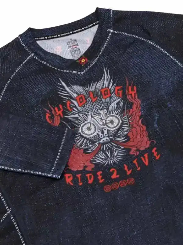 Dark denim cycling jersey with bold 'Cycology Ride 2 Live' graphic, flame accents, and bike skull design
