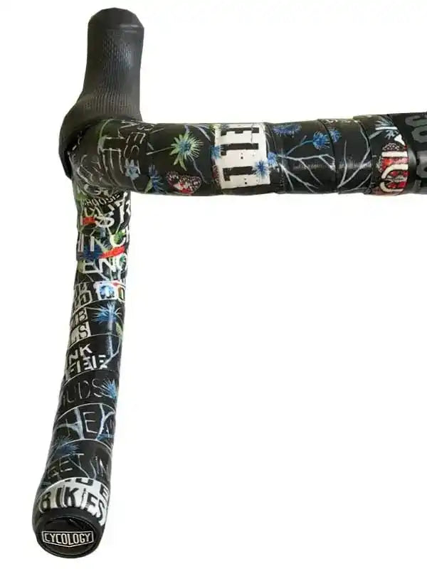 Cycology branded cycling handlebar tape with graffiti-style print and floral accents on black background