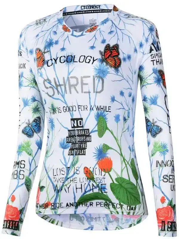 Women's long sleeve cycling jersey with butterfly and floral print, motivational text, and performance design