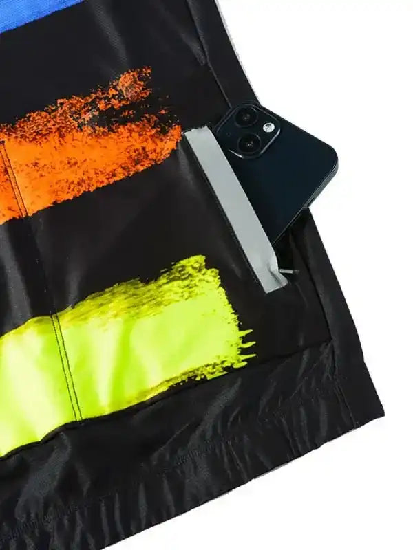 Black cycling jersey with orange and neon yellow brushstroke design, phone in back pocket
