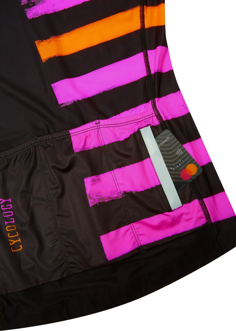 Black cycling jersey with bold pink and orange brushstroke design, featuring rear pockets holding cards