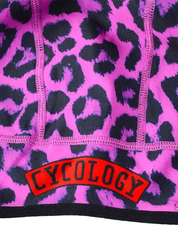 Pink leopard print cycling jersey with bold 'CYCOLOGY' logo, high-quality fabric detail