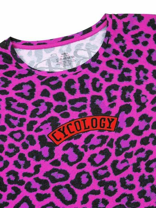 Vibrant pink leopard print cycling jersey with bold 'CYCOLOGY' logo, designed for women's bike wear.