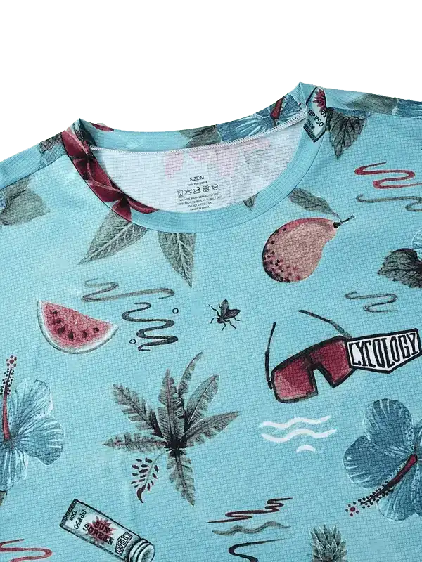 Men's cycling jersey with tropical print, hibiscus, watermelon, and sunglasses design on light blue fabric