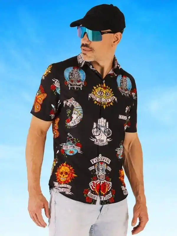 Men's black short-sleeve cycling shirt with vibrant tattoo-style graphics, worn with cap and sunglasses