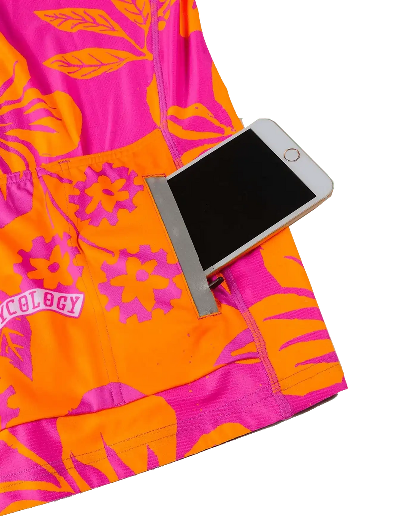 Vibrant pink and orange floral cycling jersey with phone pocket, showcasing functional design for riders.