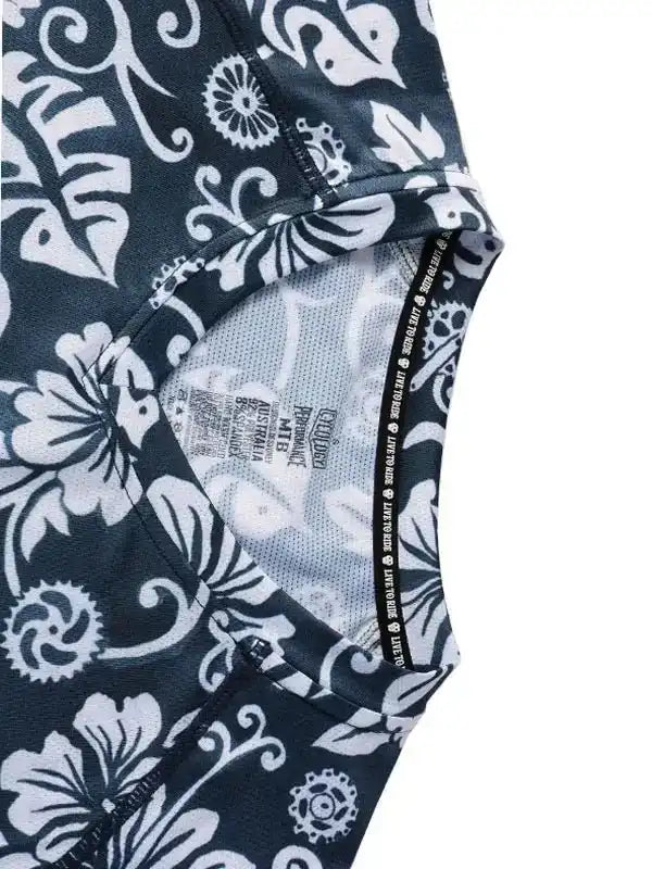 Black and white floral cycling jersey with breathable mesh lining and performance fabric details