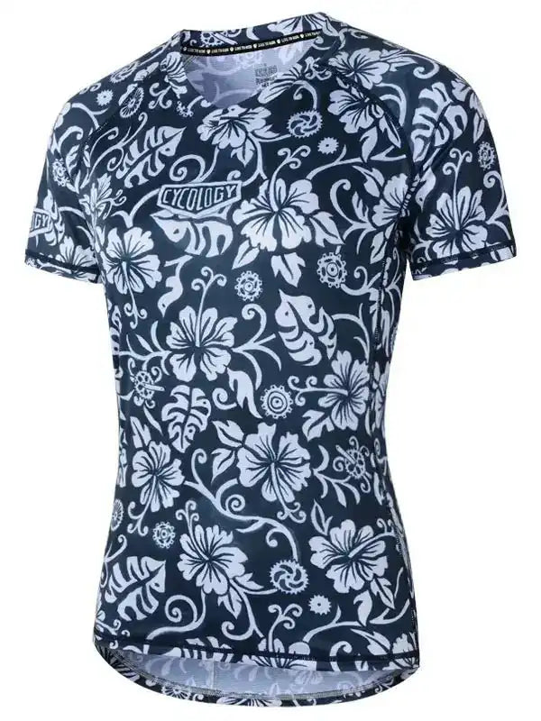 Women's cycling jersey with white floral pattern on navy blue, featuring breathable fabric and ergonomic fit