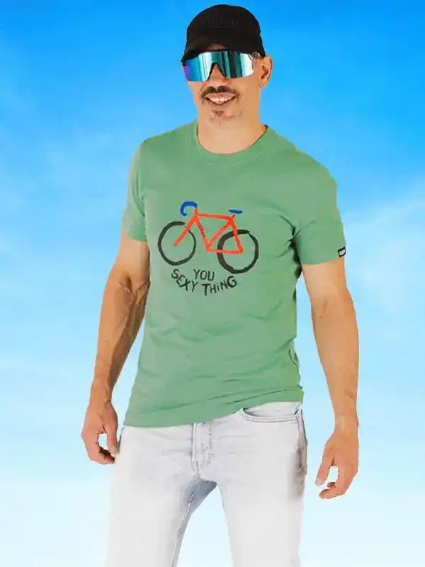 Man wearing green cycling t-shirt with 'You Sexy Thing' bike graphic, sunglasses, and cap