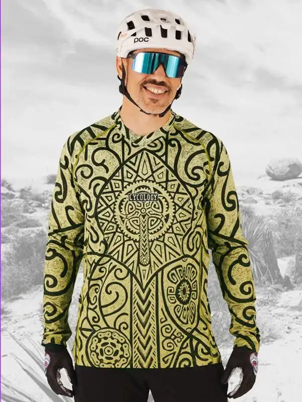 Man wearing patterned long-sleeve cycling jersey with helmet and sunglasses, ideal for mountain biking adventures.