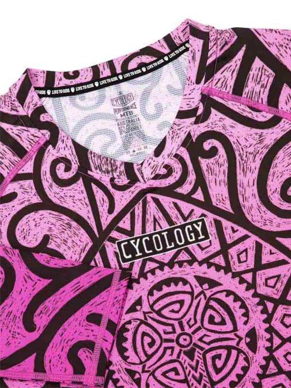 Pink and black patterned cycling jersey with 'CYCOLOGY' logo, featuring bold tribal graphics and performance fabric.